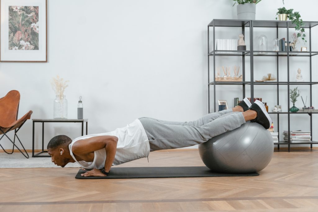 Man Exercising Wearing a White Tank Top