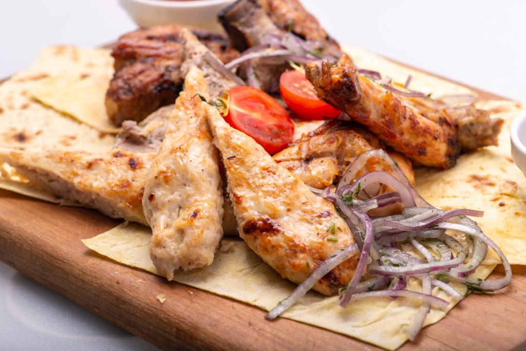 Delicious Meat Dish Served on a Wooden Tray