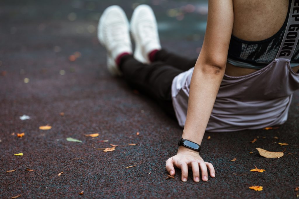 Faceless woman sitting on sports ground