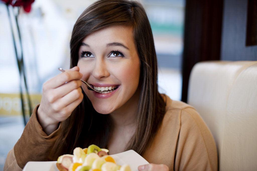 Woman eating a delicious fruit combination