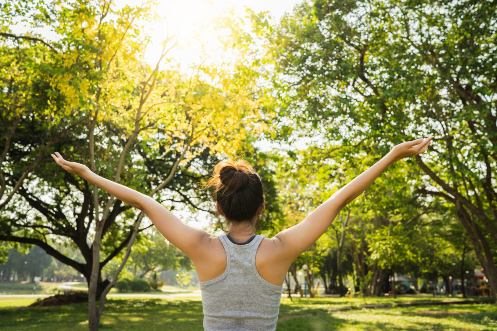 Woman stretching the body in nature