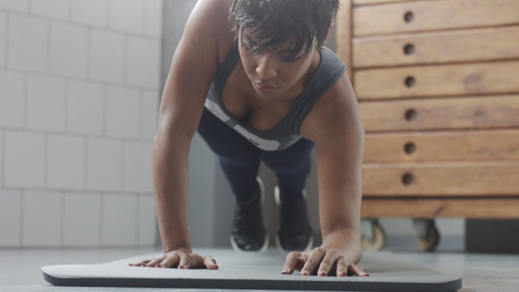 Young fit doing fitness workout with plank